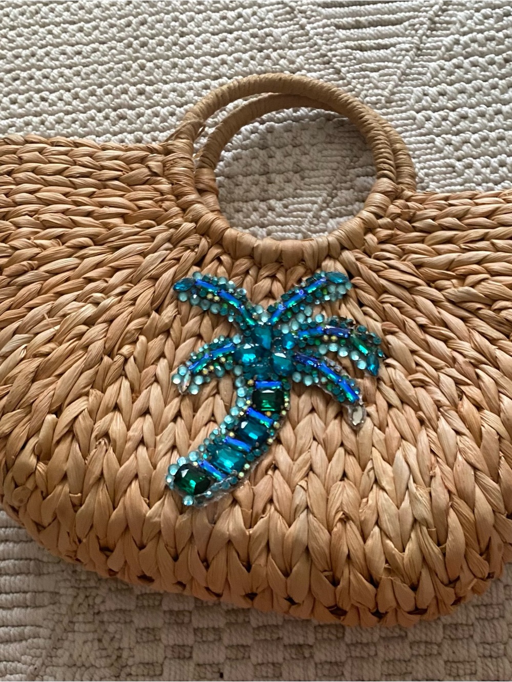 Straw bag with turquoise gems in a shape of a palm